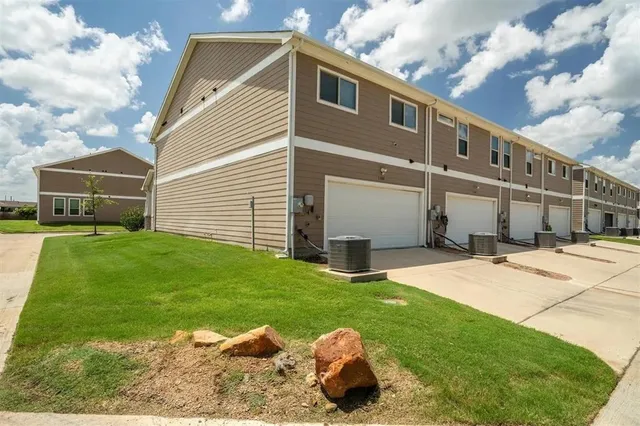 a front view of a house with a garden and yard