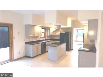 a kitchen with a refrigerator and a sink