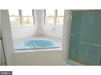 a bathroom with sink bathtub and window