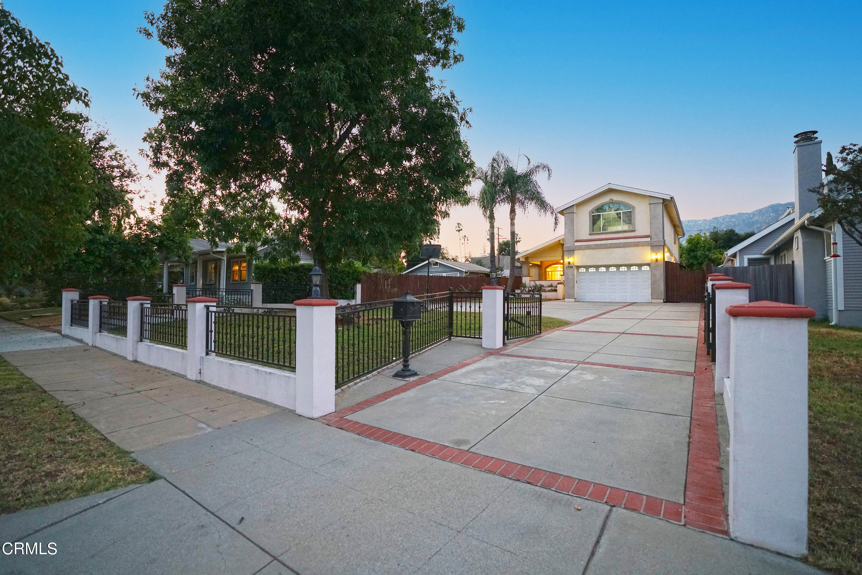 a view of a park with iron fence