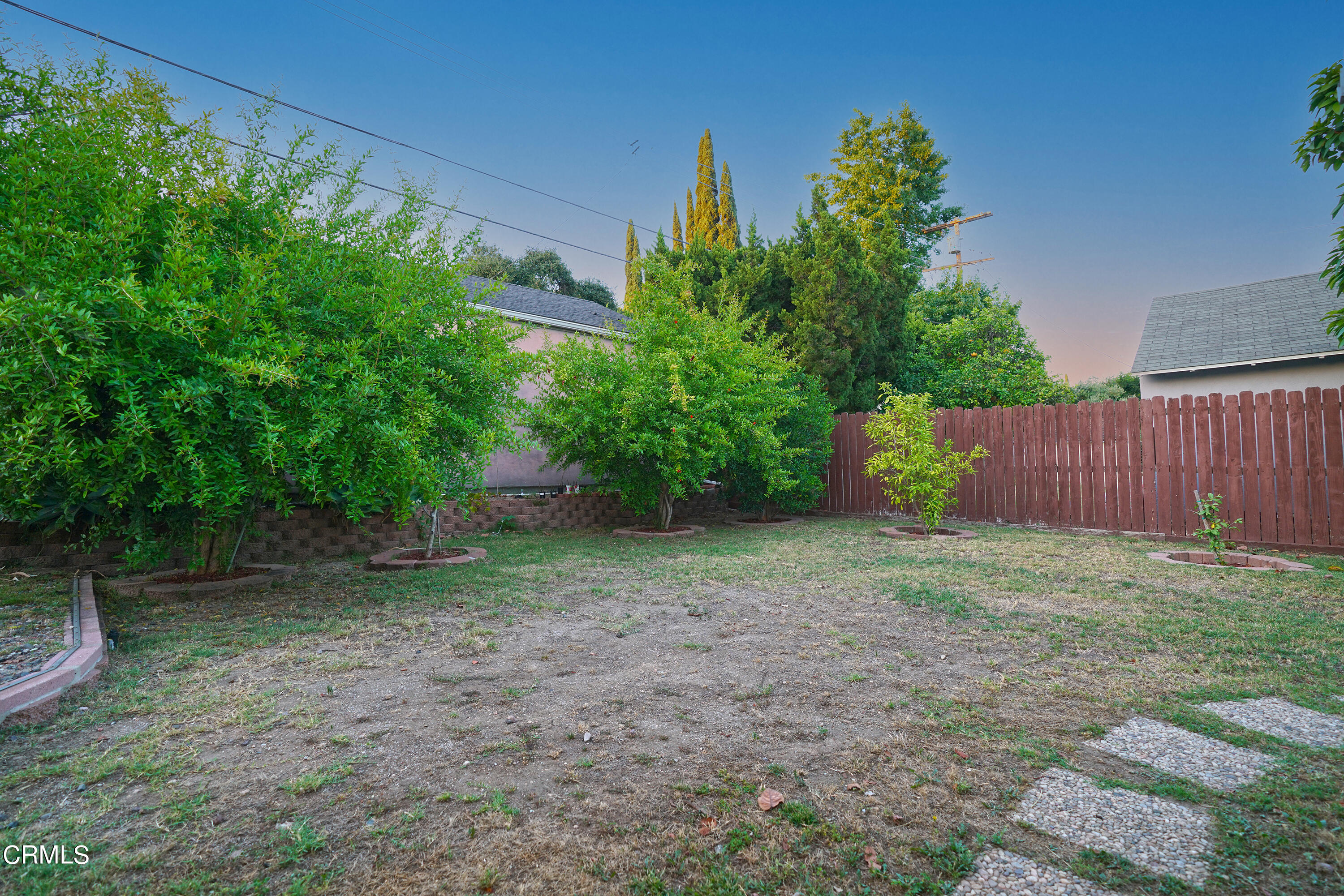 1739 Brigden Road Pasadena, CA 91104 - Photo 28 of 33 a view of a backyard with large trees and wooden fence