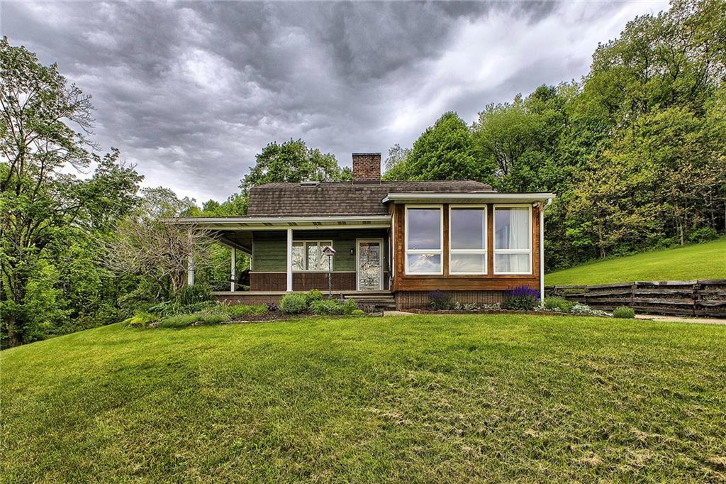 a view of a house with garden and yard