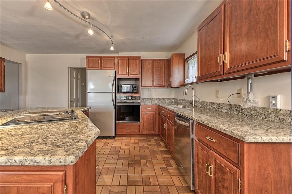 18 Rhea Road Indiana, PA 15701 - Photo 7 of 39 a kitchen with kitchen island granite countertop a sink stove and refrigerator