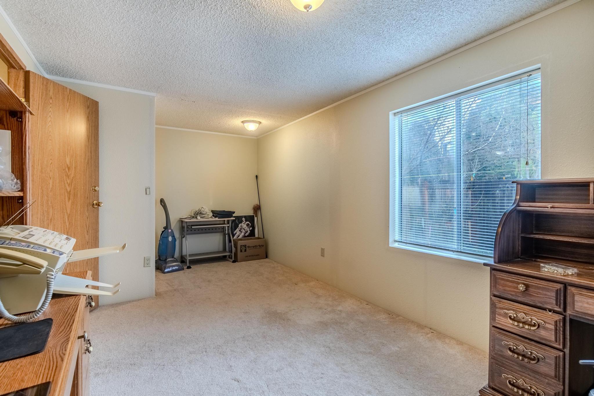 939 South Valley View Road, Unit 19 Ashland, OR 97520 - Photo 16 of 26 a living room with furniture a flat screen tv and a window