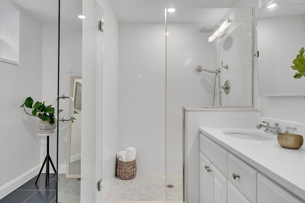 295 Beacon Street, Unit 2 Boston, MA 02116 - Photo 17 of 29 a bathroom with a sink a mirror and a shower