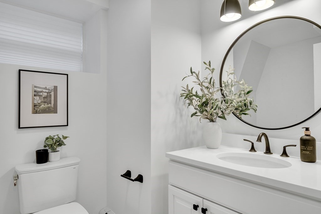 295 Beacon Street, Unit 2 Boston, MA 02116 - Photo 23 of 29 a bathroom with a sink and mirror with window