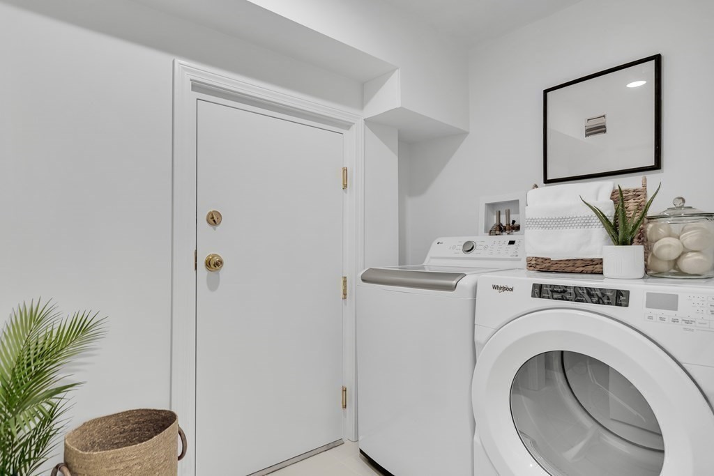 295 Beacon Street, Unit 2 Boston, MA 02116 - Photo 24 of 29 a view of washer and dryer with kitchen in the background