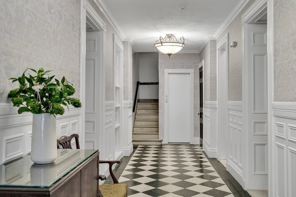 295 Beacon Street, Unit 2 Boston, MA 02116 - Photo 27 of 29 a view of a hallway with wooden floor and front door