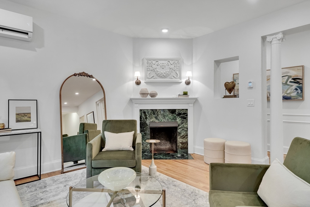 295 Beacon Street, Unit 2 Boston, MA 02116 - Photo 6 of 29 a living room with furniture and a fireplace