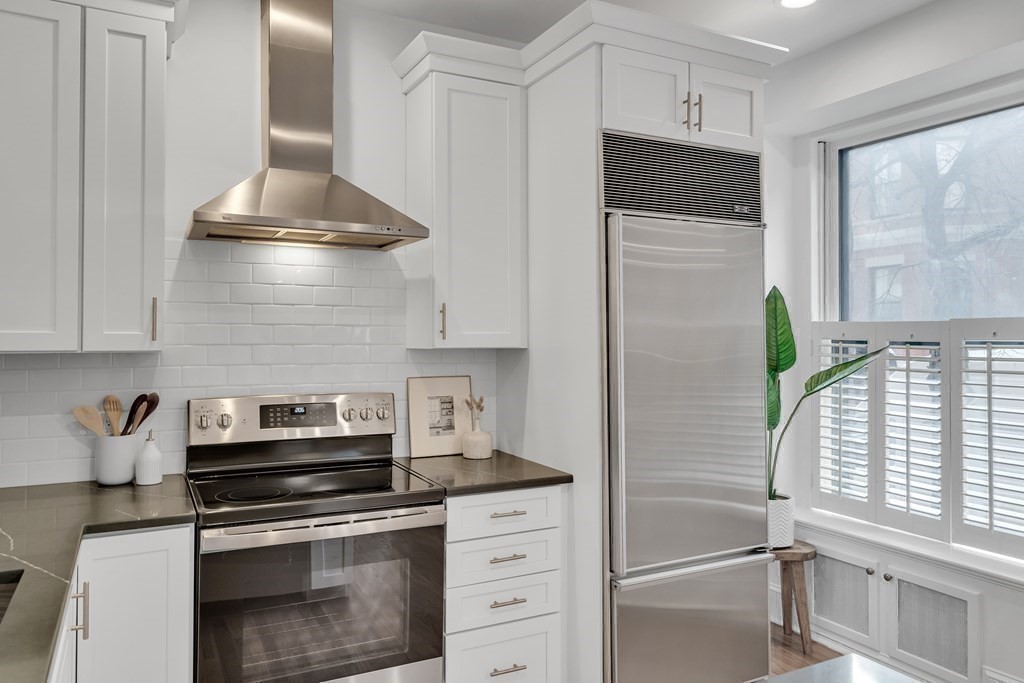 295 Beacon Street, Unit 2 Boston, MA 02116 - Photo 10 of 29 a kitchen with stainless steel appliances a stove and a refrigerator