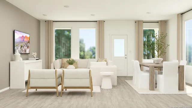 a bedroom with furniture and a large window