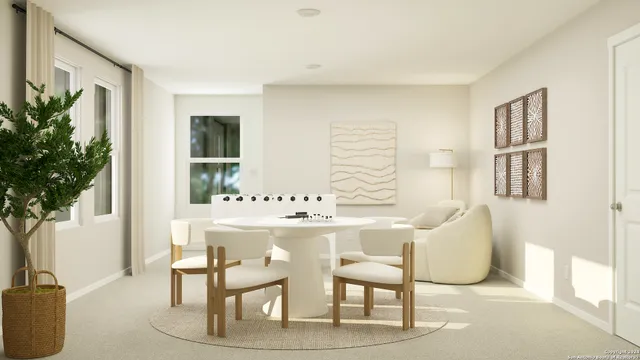 a view of a dining room with furniture and a potted plant