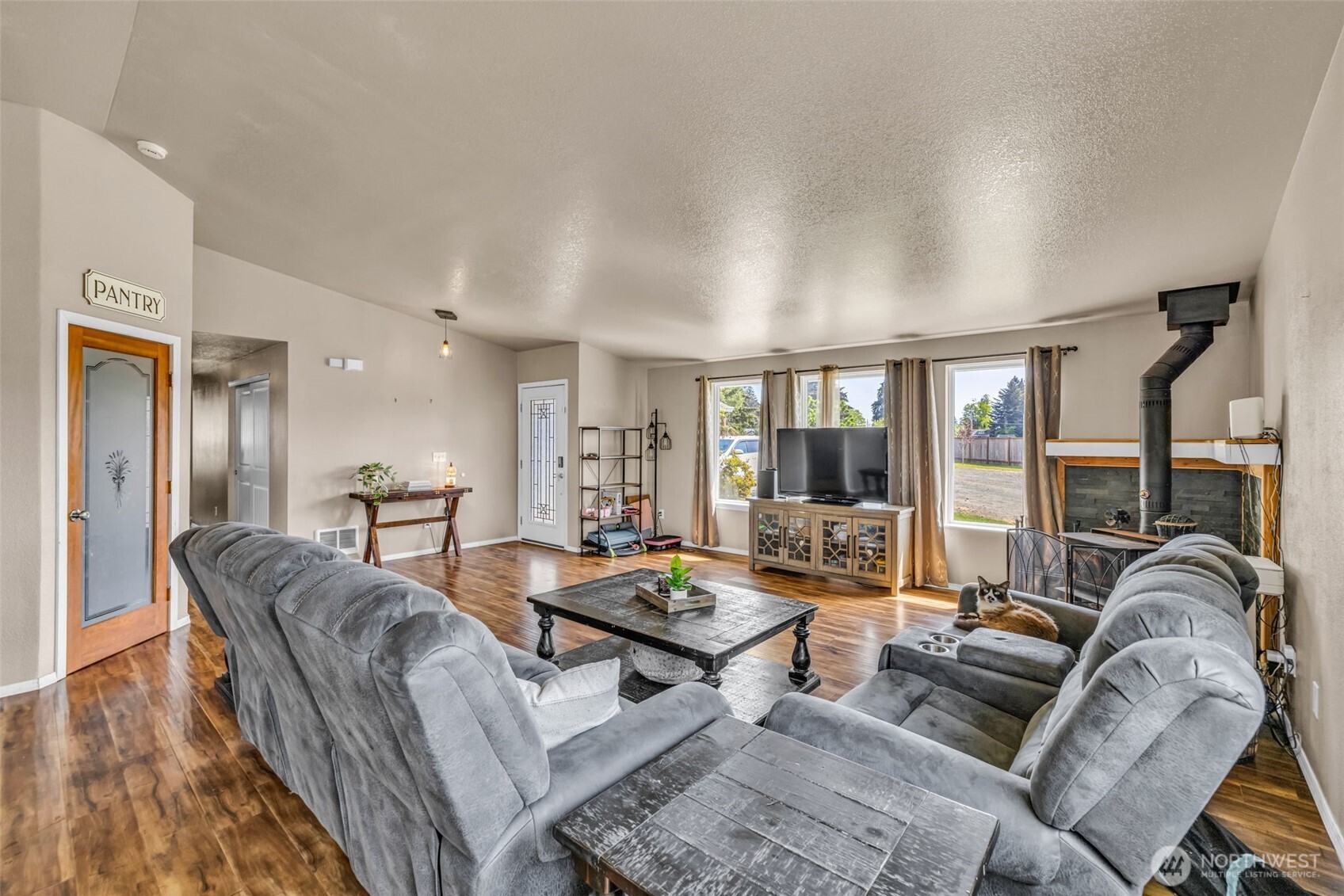 10313 School Land Road Southwest Rochester, WA 98579 - Photo 20 of 40 a living room with furniture and large windows