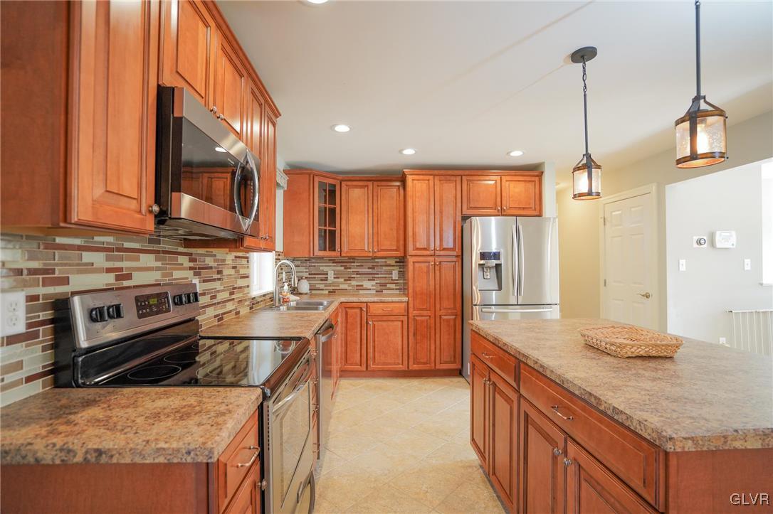 259 Owl Creek Road Tamaqua, PA 18252 - Photo 12 of 50 a kitchen with stainless steel appliances granite countertop a sink stove and refrigerator