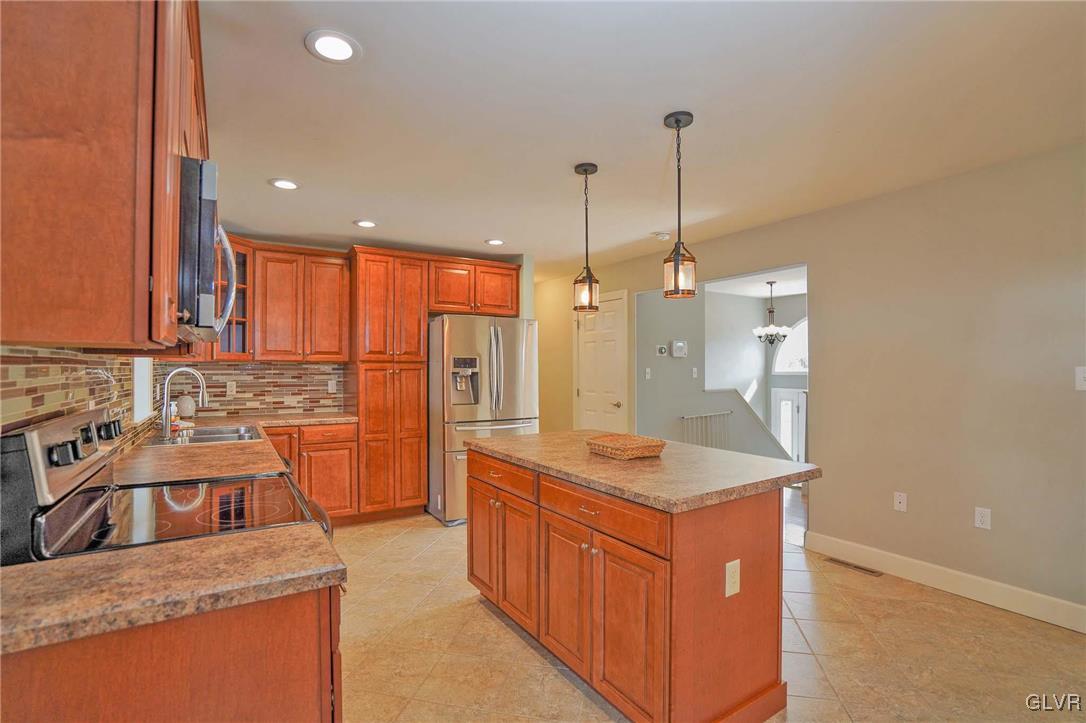 259 Owl Creek Road Tamaqua, PA 18252 - Photo 14 of 50 a kitchen with stainless steel appliances granite countertop a sink a stove and a refrigerator