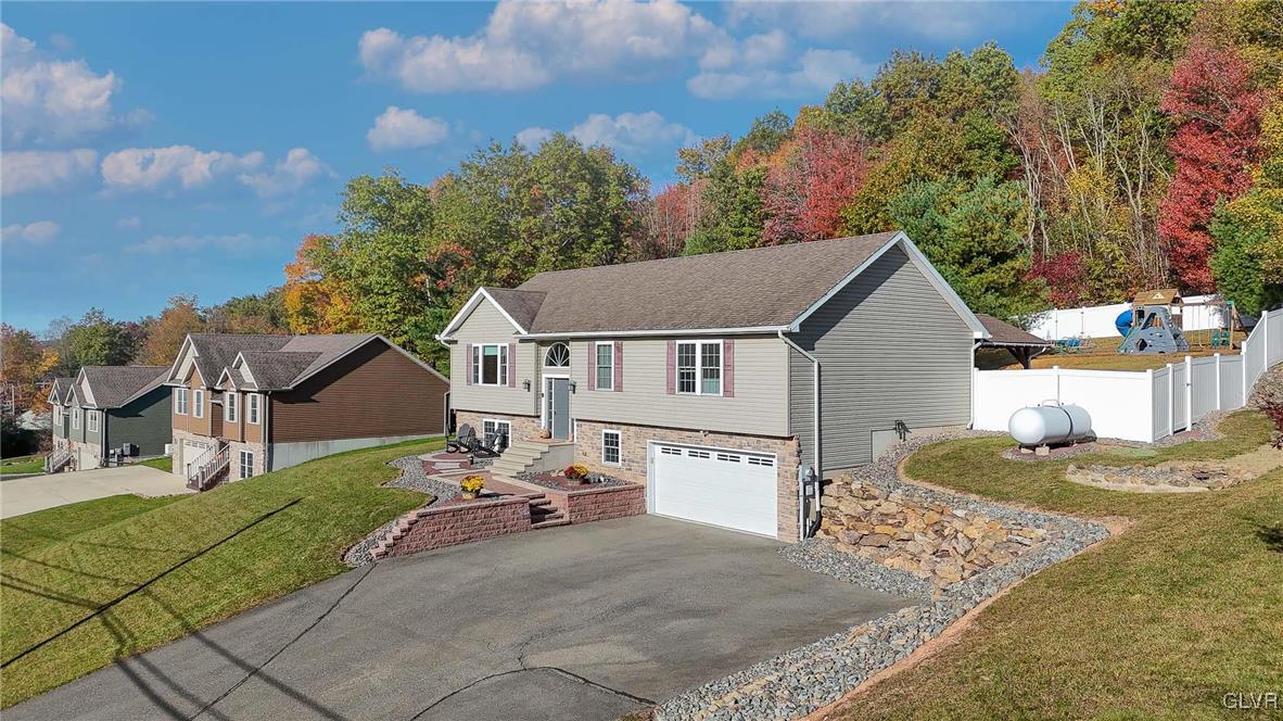 259 Owl Creek Road Tamaqua, PA 18252 - Photo 2 of 50 a view of a white house with a small yard and large trees
