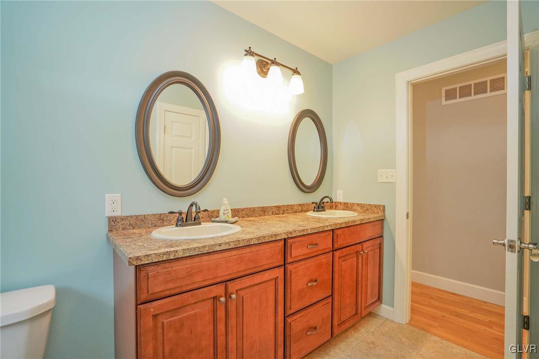 259 Owl Creek Road Tamaqua, PA 18252 - Photo 22 of 50 a bathroom with a granite countertop sink a mirror and a toilet