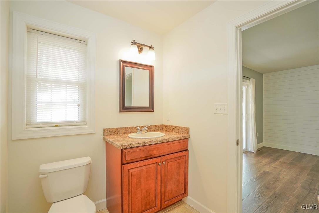 259 Owl Creek Road Tamaqua, PA 18252 - Photo 29 of 50 a bathroom with a toilet sink vanity and mirror