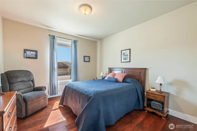 a view of a workspace with furniture and a bookshelf