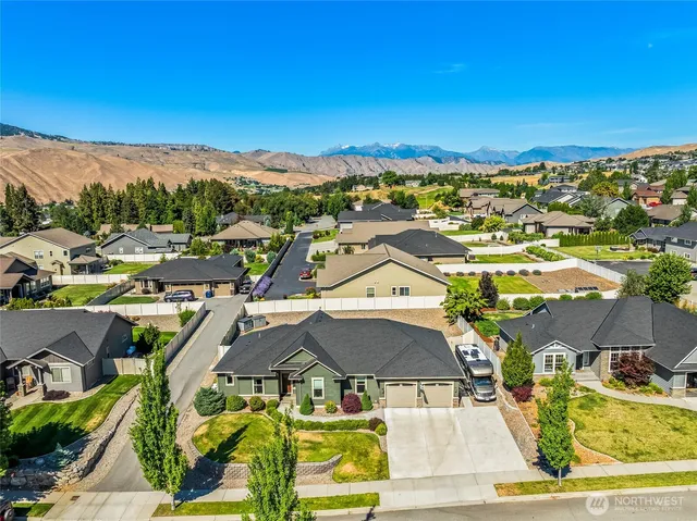 a kitchen with stainless steel appliances granite countertop a kitchen island hardwood floor sink stove dining table and chairs
