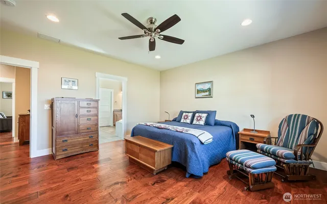 a bedroom with a bed and a ceiling fan
