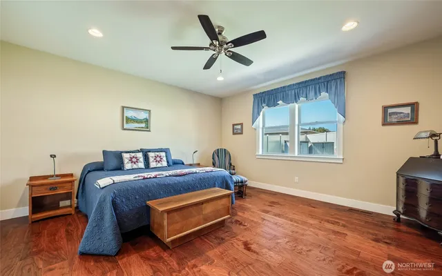 a spacious bathroom with a tub sink and mirror