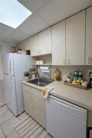 a kitchen with a refrigerator a stove a washer and dryer