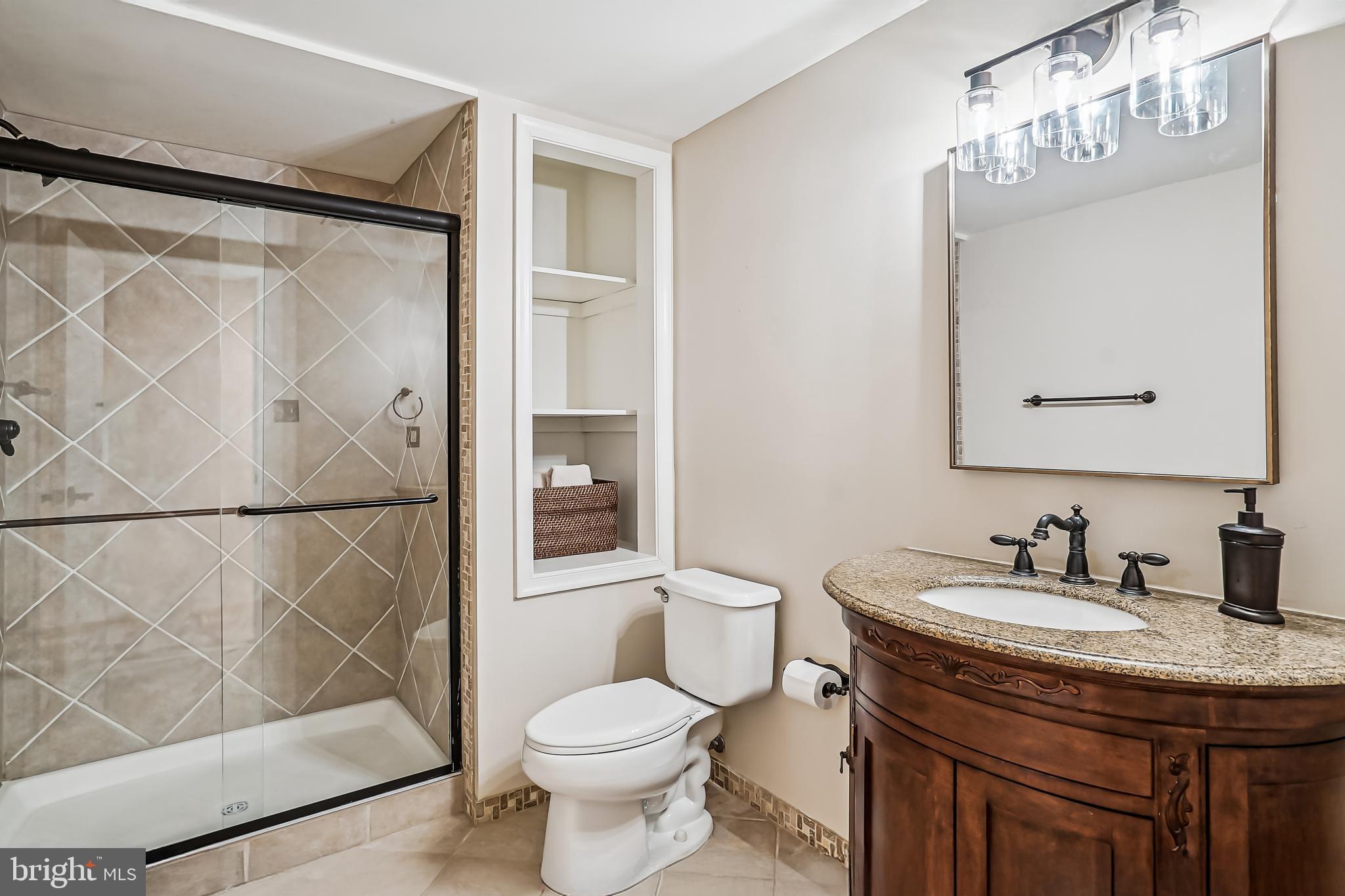 3416 Valewood Drive Oakton, VA 22124 - Photo 38 of 57 a bathroom with a granite countertop sink toilet and shower