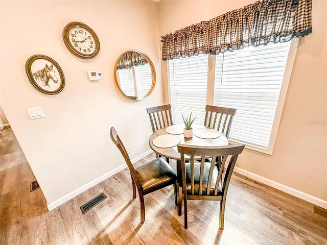 a view of a dining room with furniture and a large window