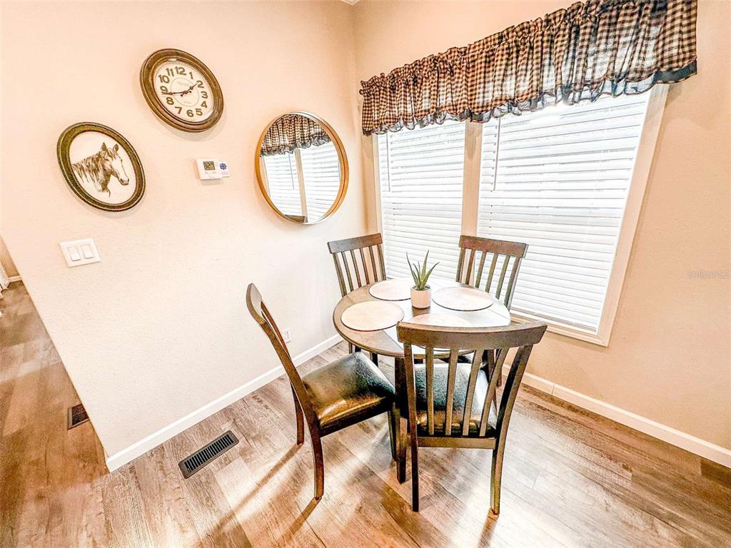 107 Long Hammock Drive River Ranch, FL 33867 - Photo 11 of 21 a view of a dining room with furniture and a large window