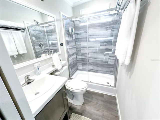 a bathroom with a sink toilet and shower