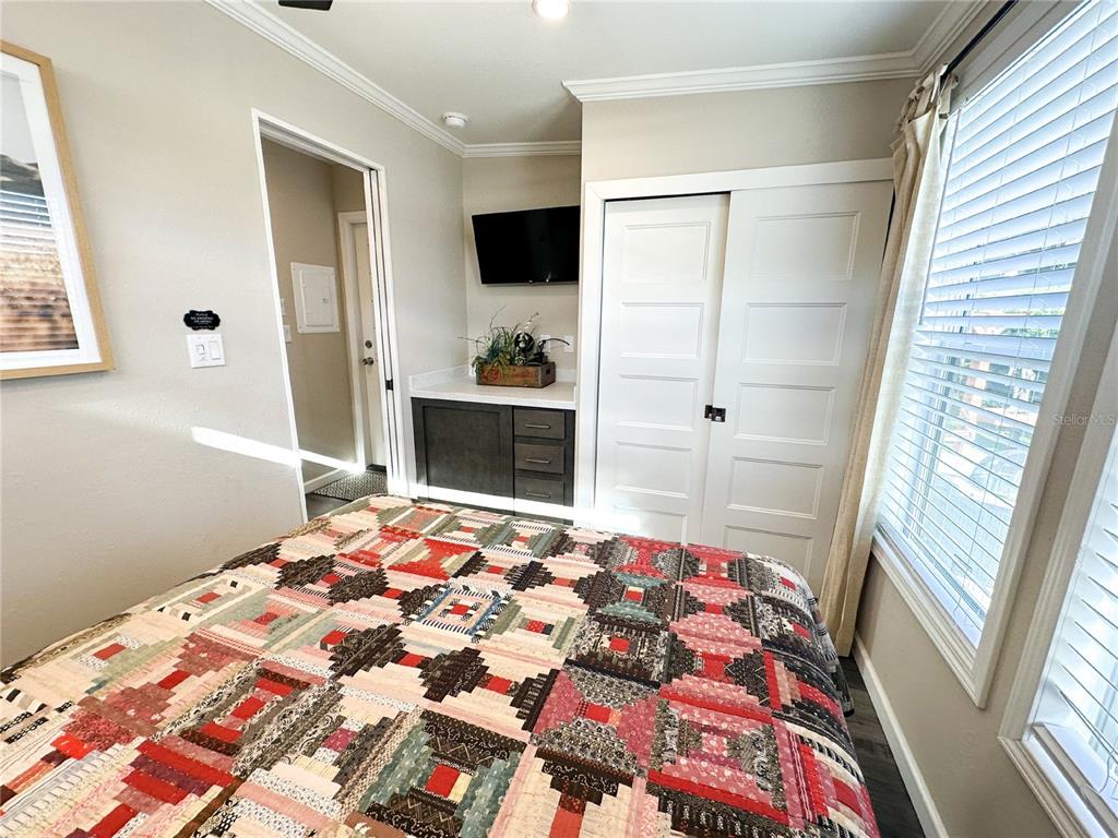 107 Long Hammock Drive River Ranch, FL 33867 - Photo 15 of 21 a bedroom with a bed and a flat screen tv