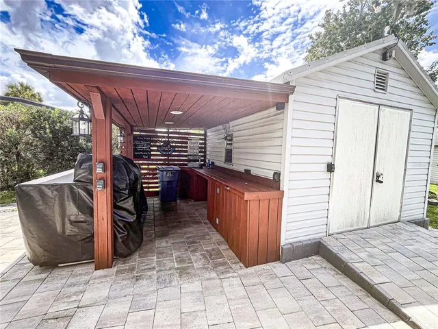 a view of a patio with table and chairs