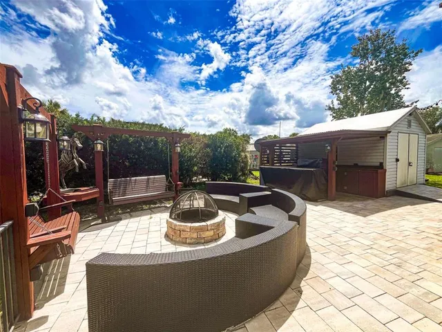 a view of a house with backyard and sitting area