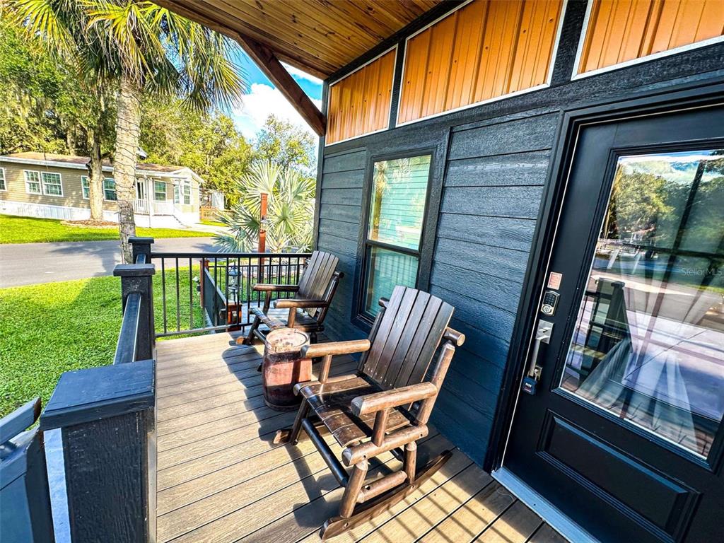 107 Long Hammock Drive River Ranch, FL 33867 - Photo 3 of 21 a view of a patio with lawn chairs floor to ceiling window next to a yard