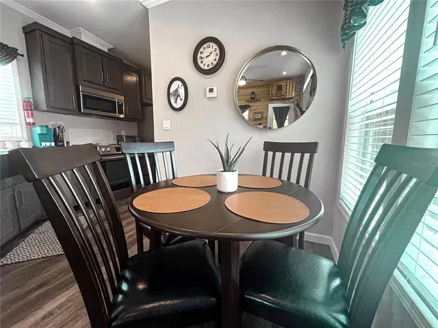 a view of a dining room with furniture window and wooden floor