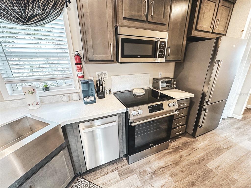 107 Long Hammock Drive River Ranch, FL 33867 - Photo 8 of 21 a kitchen with a stove microwave and sink