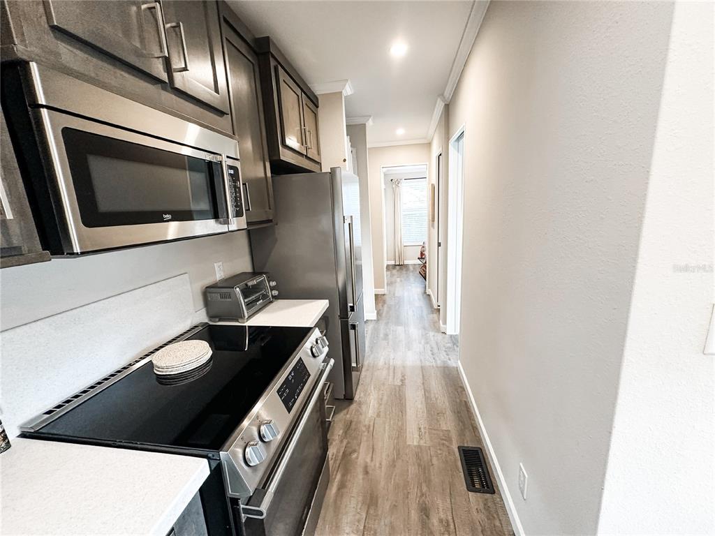 107 Long Hammock Drive River Ranch, FL 33867 - Photo 9 of 21 a kitchen with a stove and a microwave