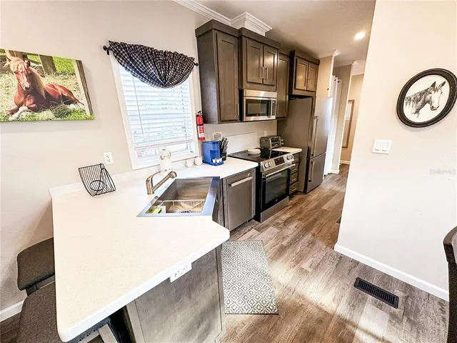 a kitchen with a sink appliances and cabinets