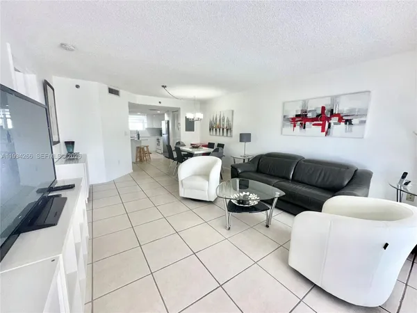 a living room with furniture and a floor to ceiling window