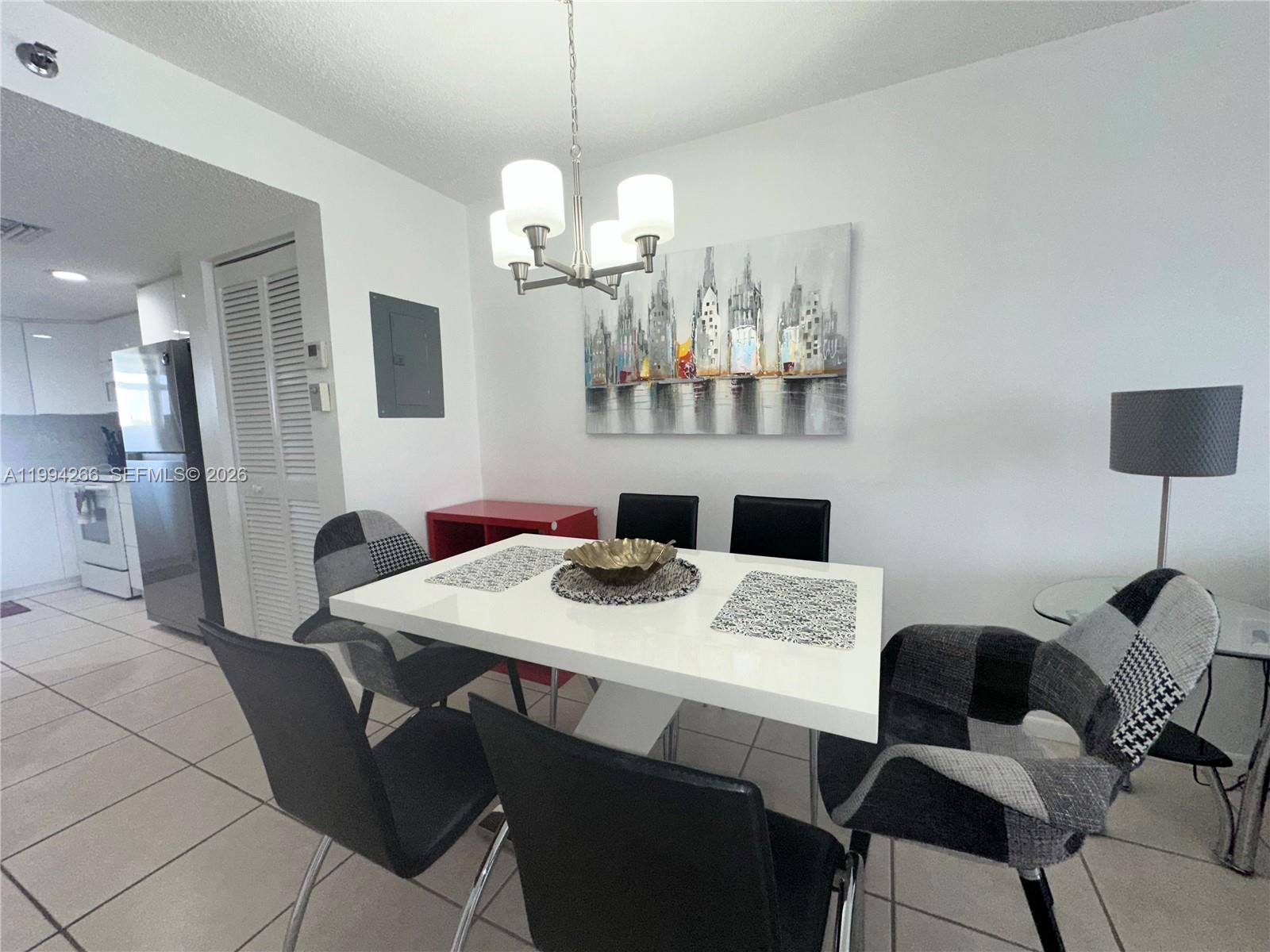 17801 North Bay Road, Unit 513 Sunny Isles Beach, FL 33160 - Photo 5 of 9 a view of a dining room with furniture and wooden floor