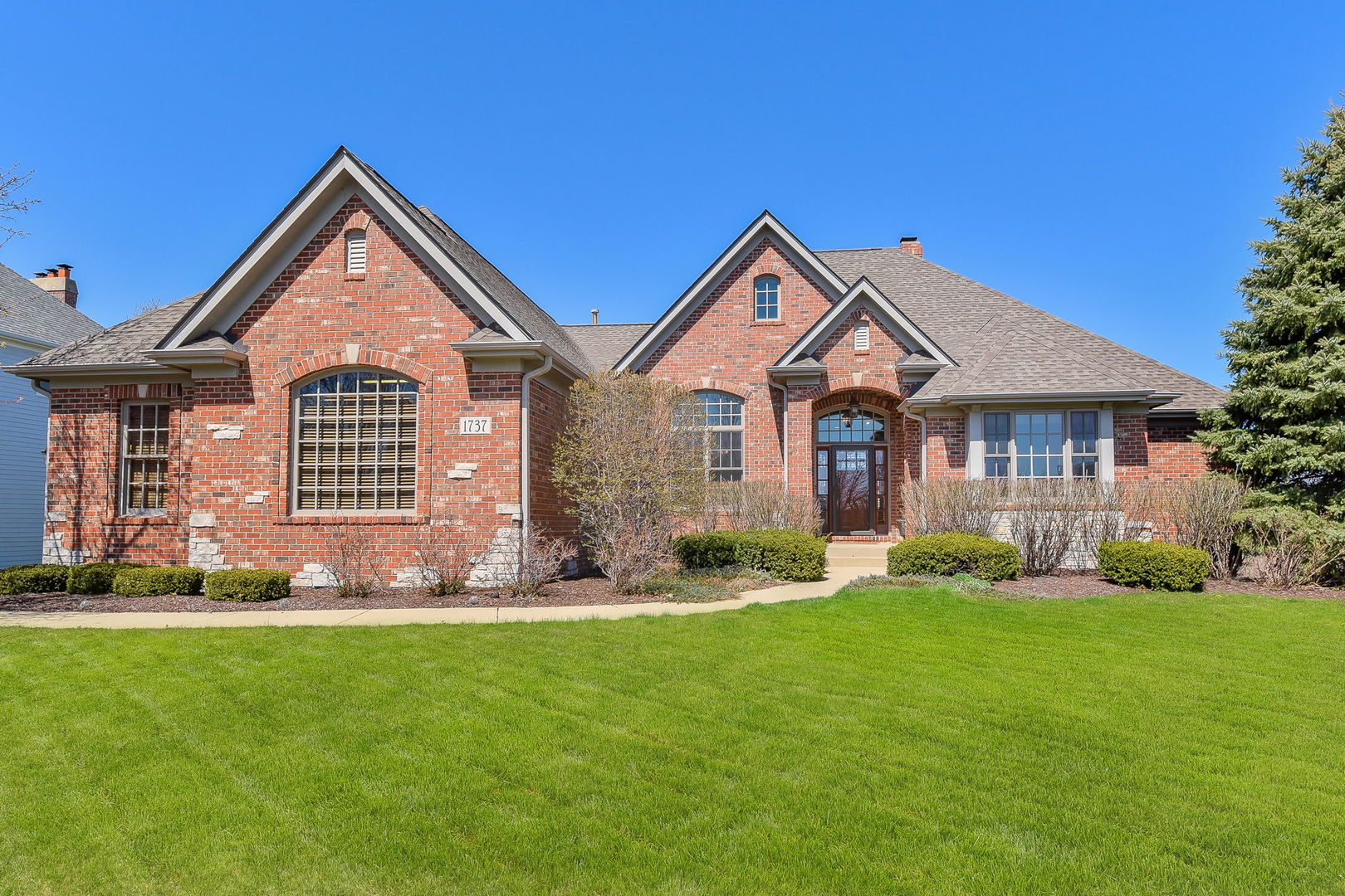 1737 Hunters Ridge Lane Sugar Grove, IL 60554 - Photo 1 of 50 a front view of a house with a yard and trees