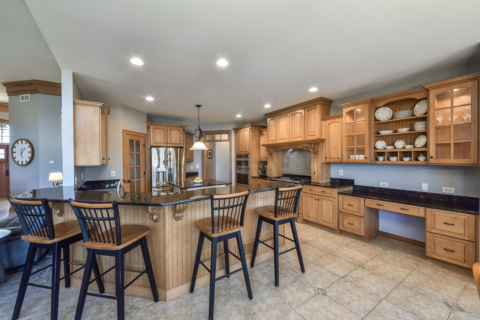 1737 Hunters Ridge Lane Sugar Grove, IL 60554 - Photo 13 of 50 a kitchen with stainless steel appliances kitchen island granite countertop a table chairs sink and cabinets