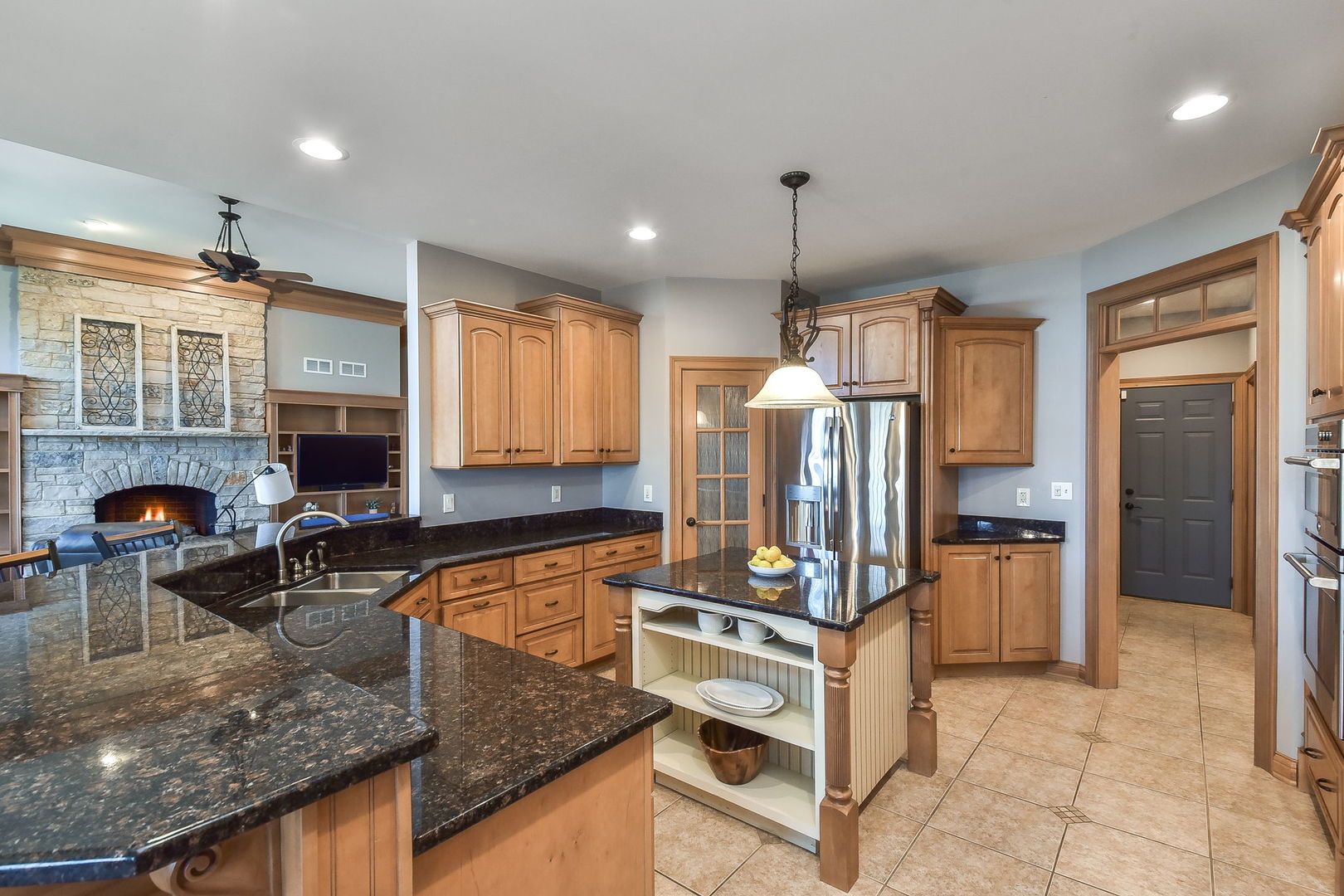 1737 Hunters Ridge Lane Sugar Grove, IL 60554 - Photo 14 of 50 a kitchen with stainless steel appliances granite countertop a refrigerator a stove and a sink with wooden cabinets