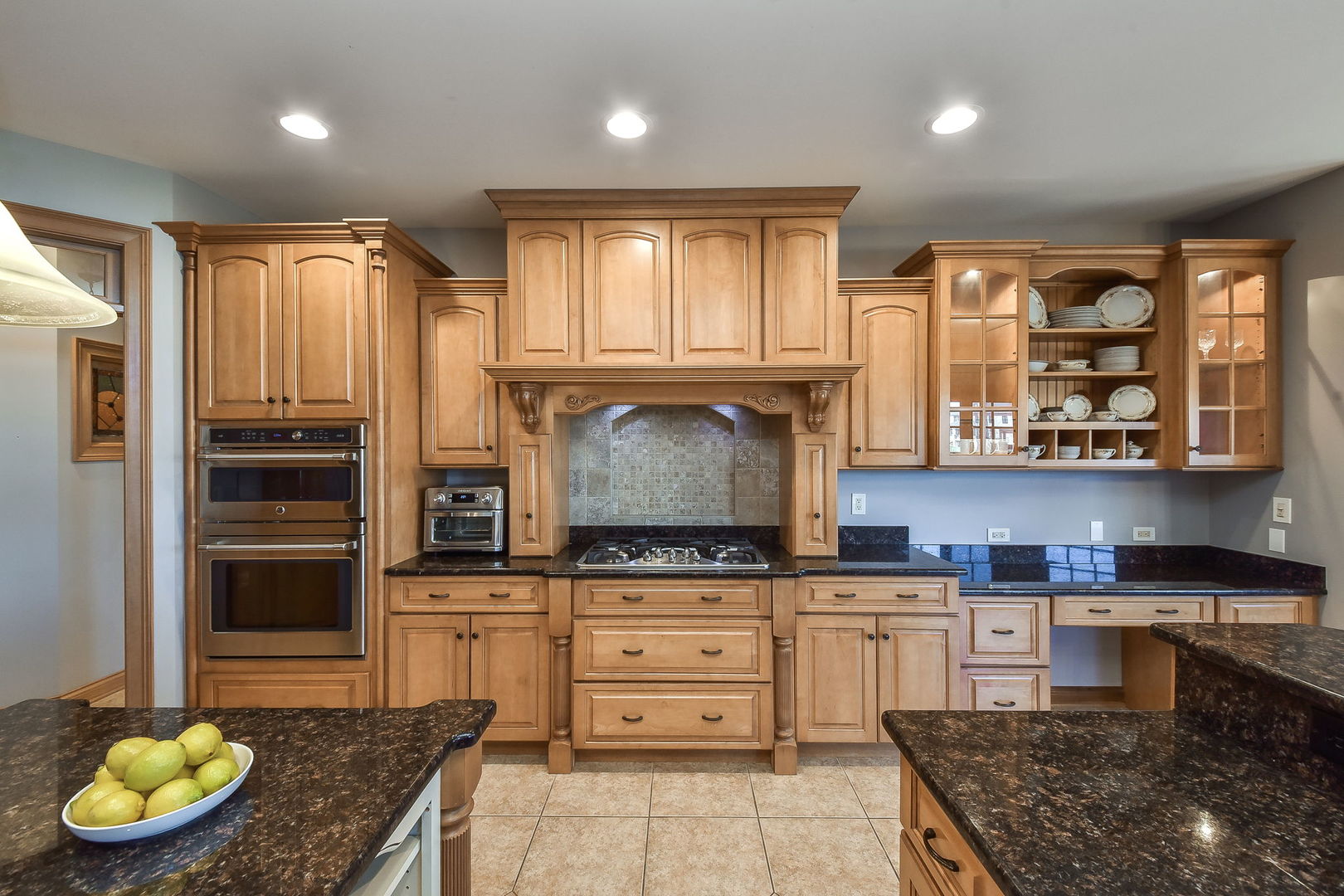 1737 Hunters Ridge Lane Sugar Grove, IL 60554 - Photo 15 of 50 a kitchen with granite countertop a stove a sink and a microwave