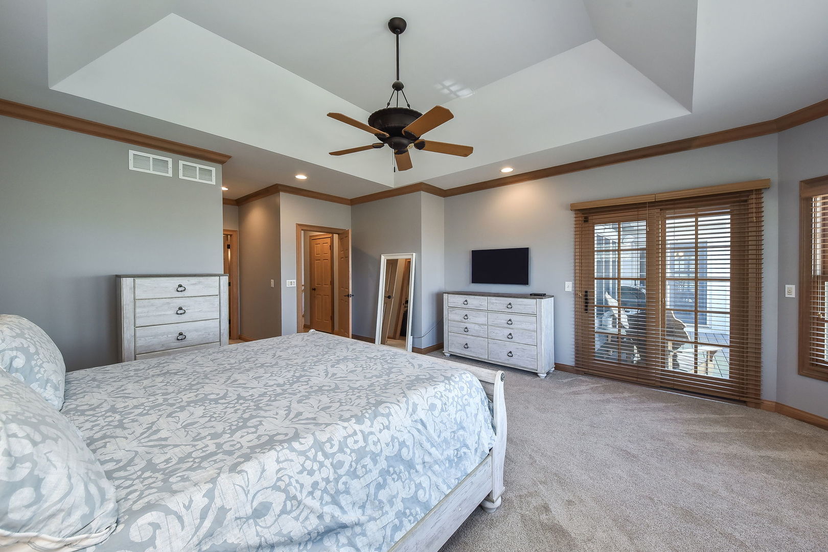 1737 Hunters Ridge Lane Sugar Grove, IL 60554 - Photo 19 of 50 a spacious bedroom with a bed a ceiling fan and a dresser