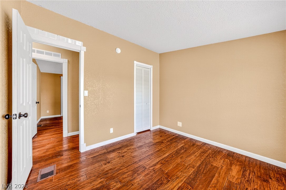 1831 West Horn Road Pahrump, NV 89048 - Photo 15 of 59 Rich hardwood flooring creates a warm and inviting atmosphere in this versatile room.