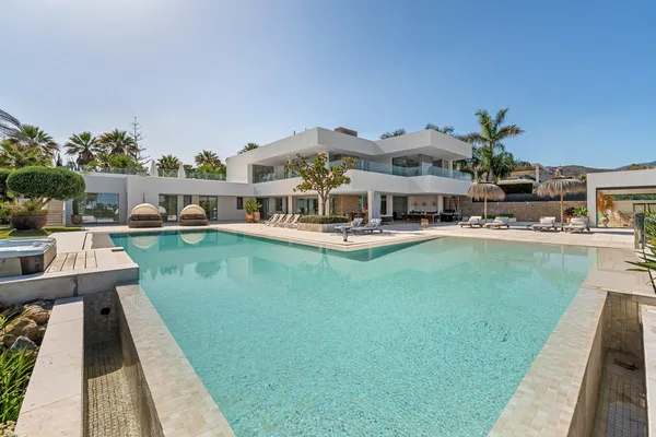 a swimming pool view with a seating space and a garden
