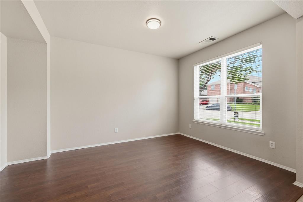 13236 Ridgepointe Road Fort Worth, TX 76244 - Photo 3 of 19 an empty room with wooden floor and windows