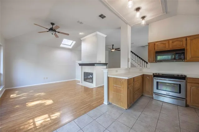 a kitchen with stainless steel appliances granite countertop a stove and a sink